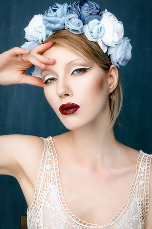 Beautiful woman with wreath on her head with bright makeupの写真素材