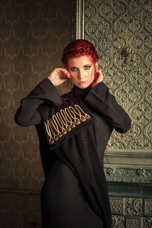 Beautiful red-haired woman in black dressの写真素材