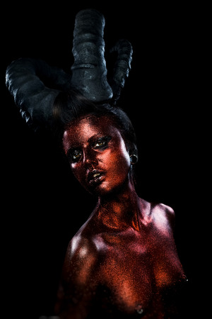 Portrait of beautiful and scary devil womanの写真素材