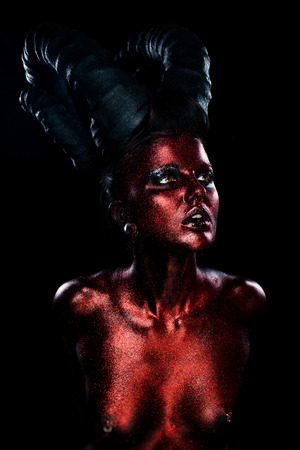 Portrait of beautiful and scary devil womanの写真素材