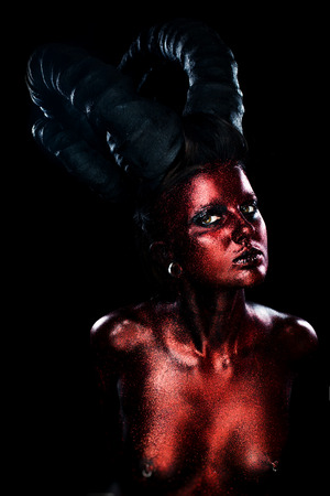 Portrait of beautiful and scary devil womanの写真素材