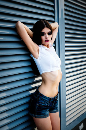 beautiful young brunette woman on streetの写真素材