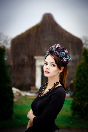Sensual pretty woman wearing floral wreath over natural backgroundの写真素材