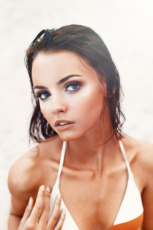 Pretty woman face close up. Beauty Girl Relaxed on the Beach, Summer Holiday and Vacation conceptの写真素材
