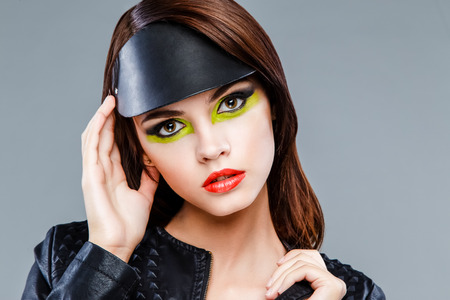 Pretty brunette female fashion model face with bright make up. Beauty Woman face Portrait with Vivid Makeup. Fashion Girl close up. Bright Colors.の写真素材