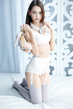 Beautiful girl dressed in white lingerieの写真素材