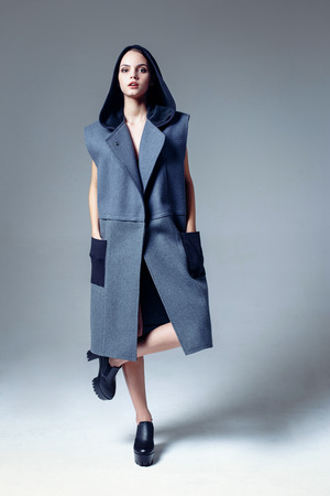 Beautiful young woman dressed in a coatの写真素材