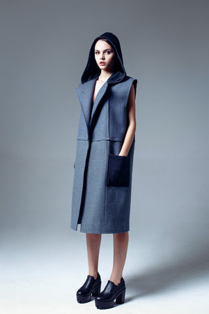 Beautiful young woman dressed in a coatの写真素材