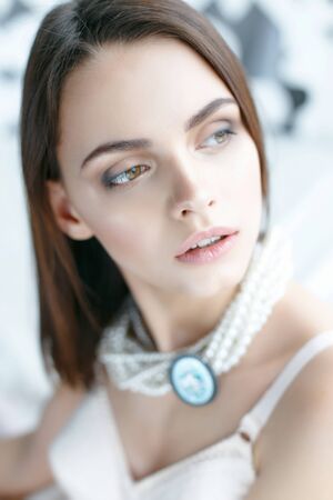 Portrait of a beautiful woman on a gray backgroundの写真素材