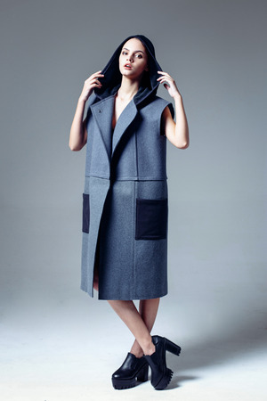 Beautiful young woman dressed in a coatの写真素材