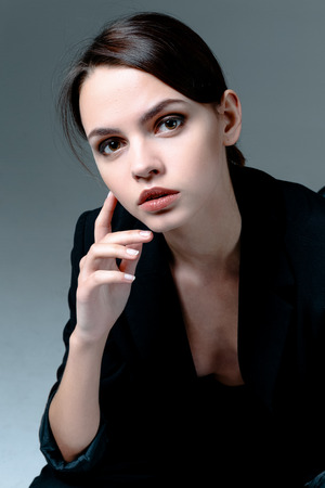 Portrait of cute brunette woman wearing a jacket over naked bodyの写真素材