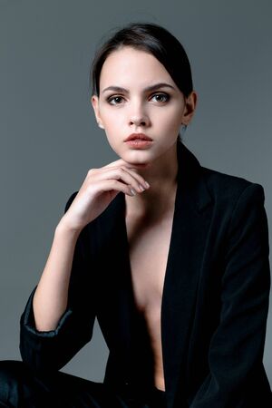 Portrait of cute brunette woman wearing a jacket over naked bodyの写真素材