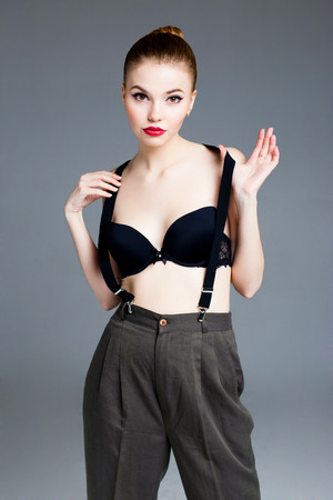 Beautiful female fashion model wearing bra and suspendersの写真素材