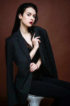 Portrait of beautiful brunette female model posing in studioの写真素材