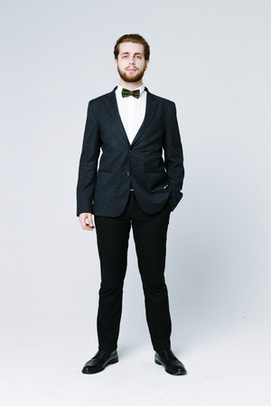 Handsome man in suit on grey backgroundの写真素材