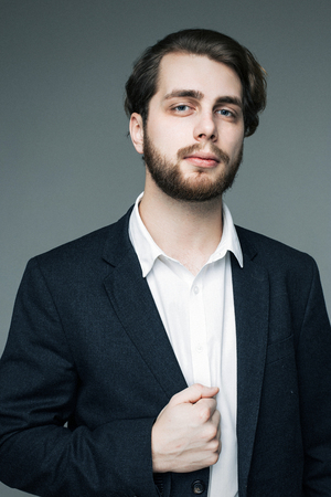 Handsome man in suit on grey backgroundの写真素材