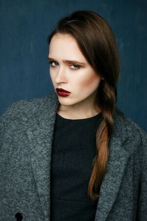 Beauty fashion girl wearing in coat. Beauty female. Perfect skin and make up.の写真素材