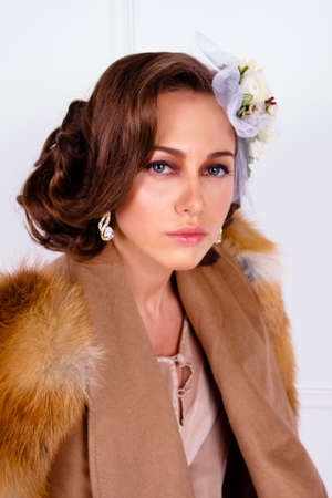 pretty woman wearing elegant trendy fashion clothes and flowers on hairの写真素材
