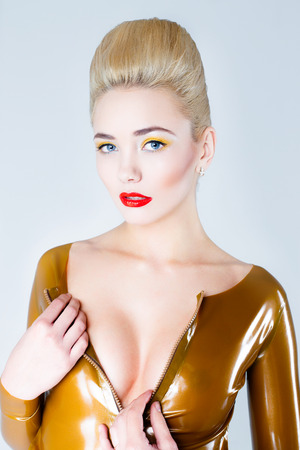 Pretty blonde female model face with artistic make up. Woman with red lips, white hair and pale skinの写真素材