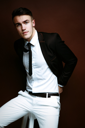 Portrait of handsome stylish man in elegant black suitの写真素材