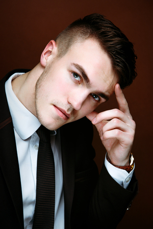Portrait of handsome stylish man in elegant black suitの写真素材