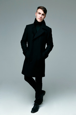 Full length of handsome stylish man in coatの写真素材