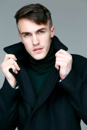 Portrait of handsome stylish man in coatの写真素材