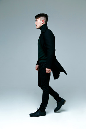 Full length of handsome stylish man in coatの写真素材