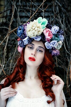 Sensual sexy woman face wearing floral wreath on brick wall backgroundの写真素材