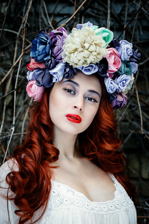 Sensual sexy woman face wearing floral wreath on brick wall backgroundの写真素材