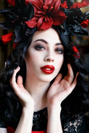 Portrait of a beautiful young woman in a wreath on had. beauty girl with red lips. Female face with clear skin close-up. Skincareの写真素材