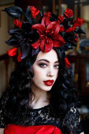 Portrait of a beautiful young woman in a wreath on had. beauty girl with red lips. Female face with clear skin close-up. Skincareの写真素材