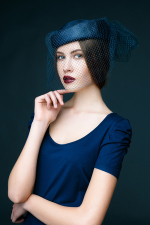 Beauty fashion girl. Portrait of beautiful young woman with fresh clean skin on grey backgroundの写真素材