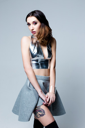 Cute Woman in futuristic creative metallic costumeの写真素材