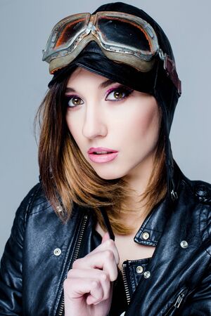 Portrait of Sexy biker woman with US Army-style motorcycle helmet with gogglesの写真素材