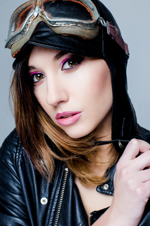 Portrait of Sexy biker woman with US Army-style motorcycle helmet with gogglesの写真素材