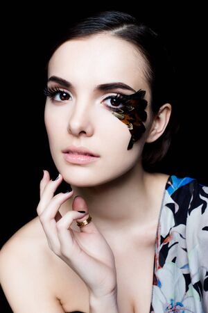 Portrait of pretty woman face with false feather eyelashes fashion makeupの写真素材