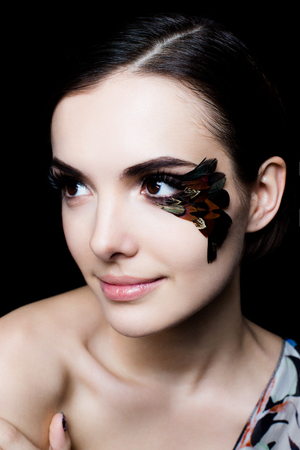 Portrait of pretty woman face with false feather eyelashes fashion makeupの写真素材