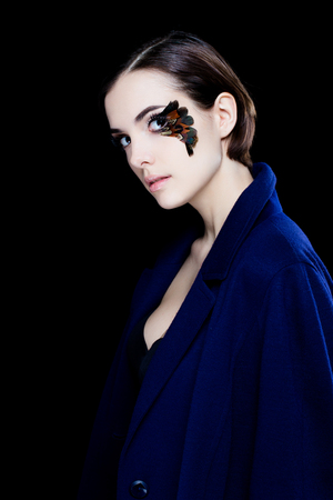 Portrait of pretty woman face with false feather eyelashes fashion makeupの写真素材