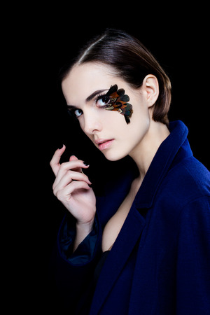 Portrait of pretty woman face with false feather eyelashes fashion makeupの写真素材