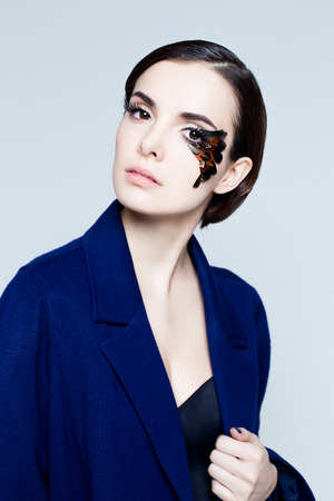 Portrait of pretty woman face with false feather eyelashes fashion makeupの写真素材