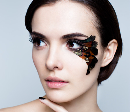 Portrait of pretty woman face with false feather eyelashes fashion makeupの写真素材