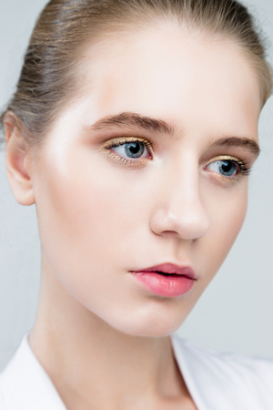 Beauty fashion girl. Portrait of beautiful young woman with fresh clean skin on grey backgroundの写真素材