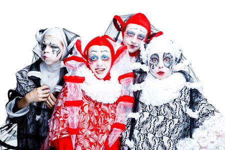 Four cheerful clown in a vintage style with a typical makeup on white backgroundの写真素材