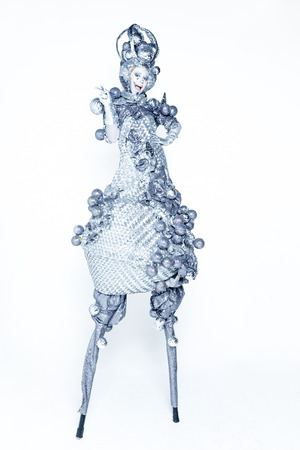 A woman dressed in luxury carnival costume silver light bulbの写真素材