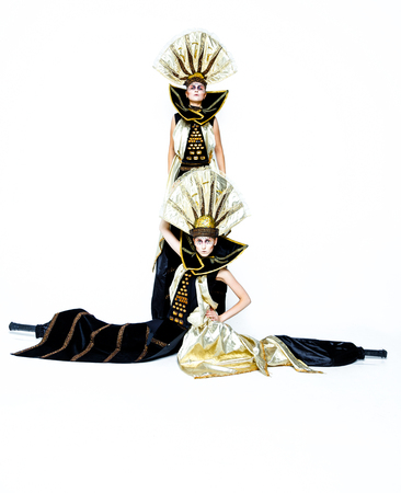 Beautiful Golden Venetian Carnival Masked women on white background, sun costumeの写真素材