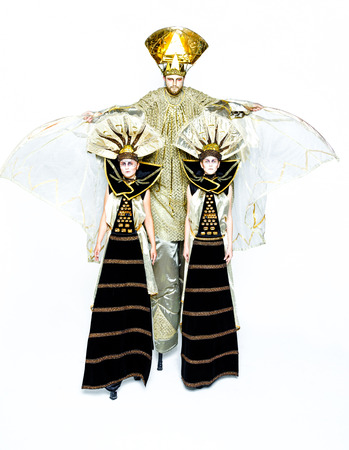 Beautiful Golden Venetian Carnival Masked man and two women on white background, sun costumeの写真素材