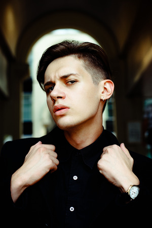 Close up portrait of handsome young man walkingの写真素材