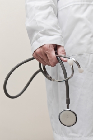 Doctor s hand holding stethoscope on clear backgroundDoctorの写真素材