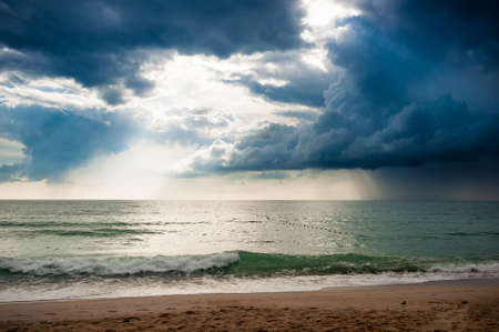 Storm cloud in the sea with the beachの写真素材